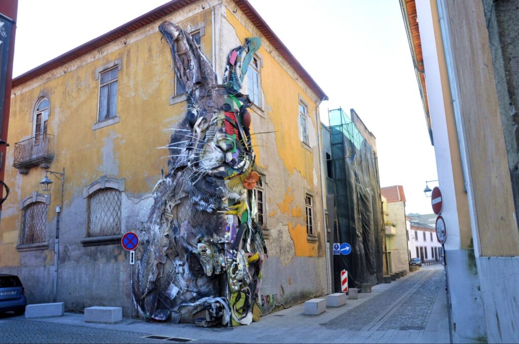 Bordalo II in Porto created innovative urban street art featuring 'Half Rabbit,' a large-scale sculpture made from recycled materials.