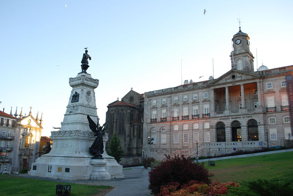 An exterior view of the neoclassical Palácio da Bolsa in Porto showcases its intricate façade and grand entrance.