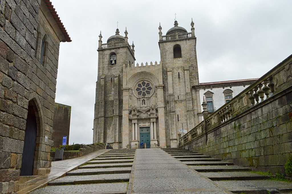 The imposing facade of Porto Cathedral, a blend of Romanesque and Gothic architectural styles, towering over the city.